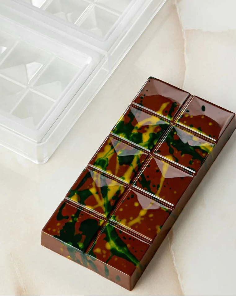 Chocolate bar with a tie-dye design on a light surface